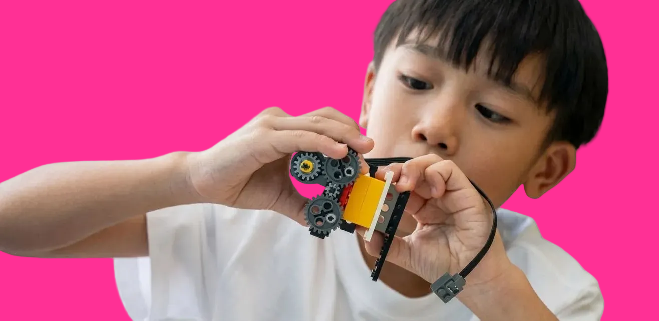 Child assembling gear model at Young Engineers program Toronto