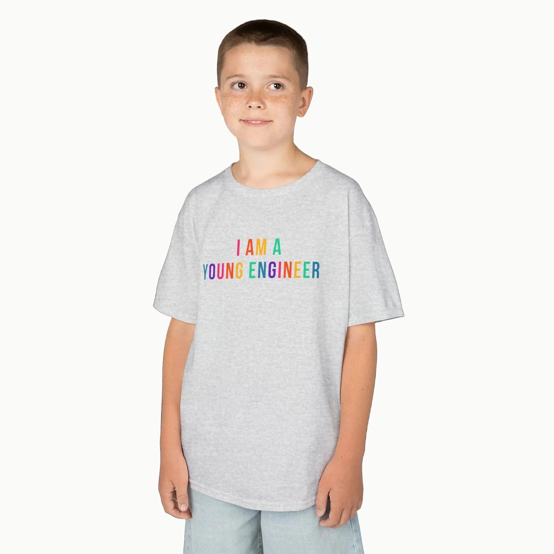 Child wearing a gray t-shirt with 'I AM A YOUNG ENGINEER' text on a white background